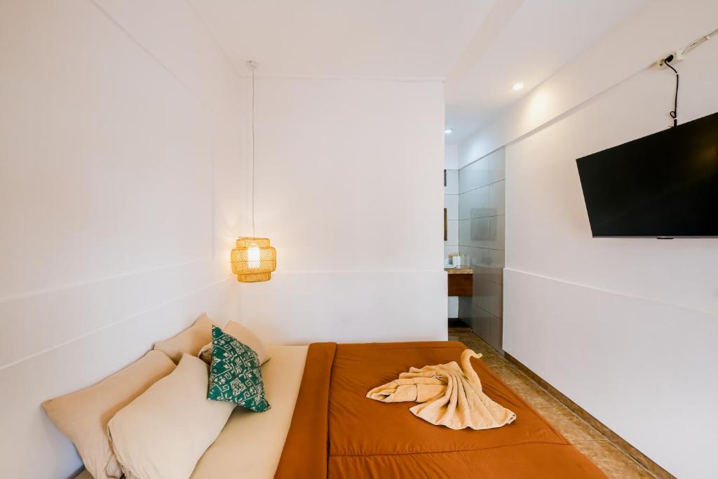 Soka Suarsena bedroom with wall-mounted TV